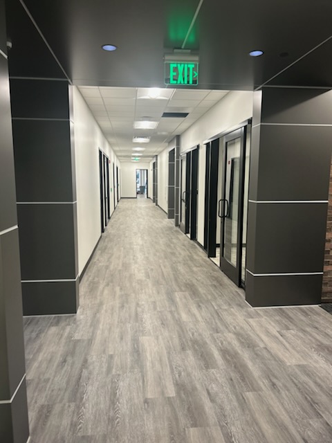 Finished commercial corridor with drywall, glass fronts and ceiling detail